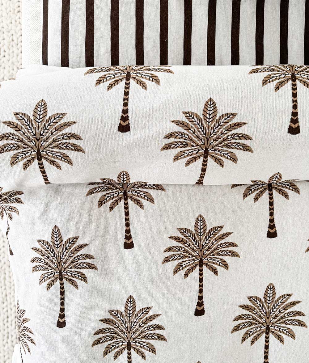 Close-up of the Khaki Sundown jersey cotton duvet cover with chocolate and khaki palm tree print.