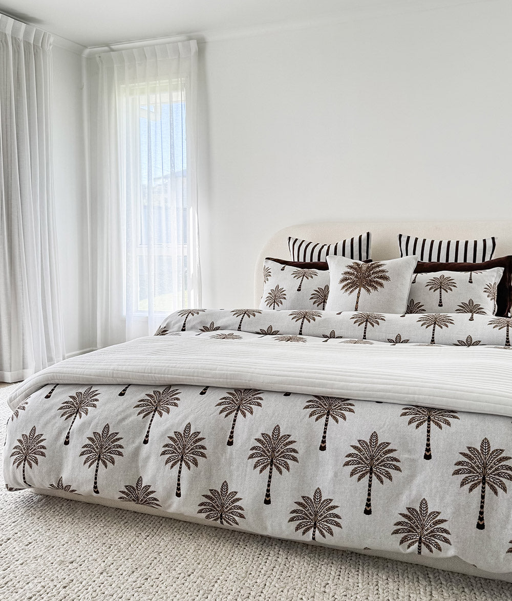 Khaki Sundown reversible quilt styled on a queen bed.