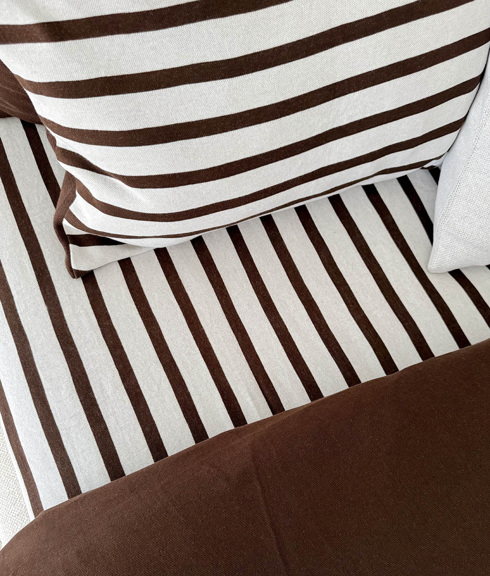 Close-up of the Sundown Stripe jersey cotton fitted sheet.