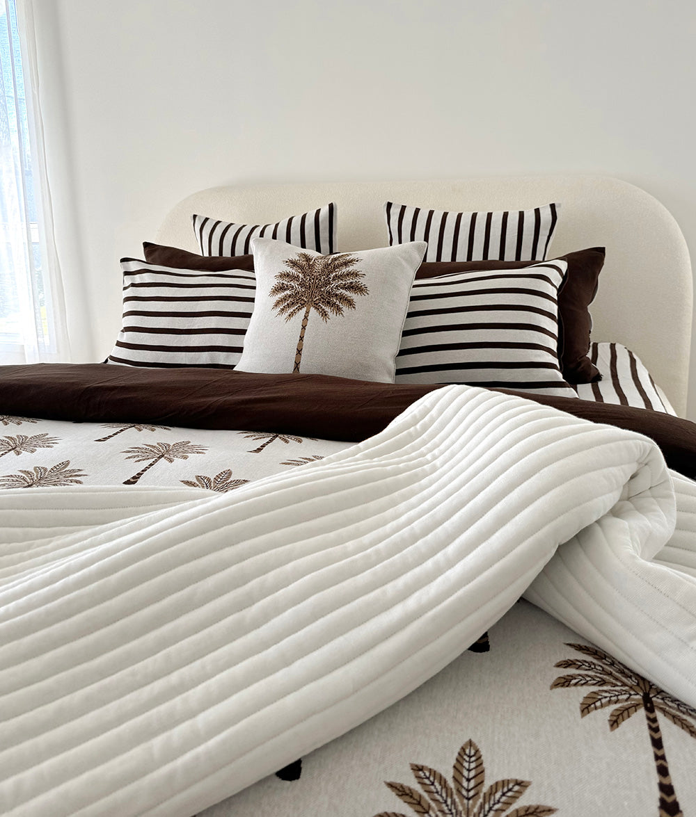 Sundown Stripe Euro pillowcase styled with the Khaki Sundown reversible quilt.
