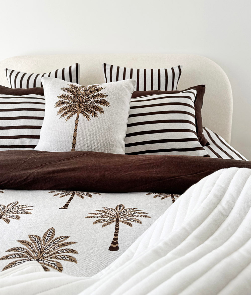Khaki Sundown jersey cotton duvet cover styled on a made bed.