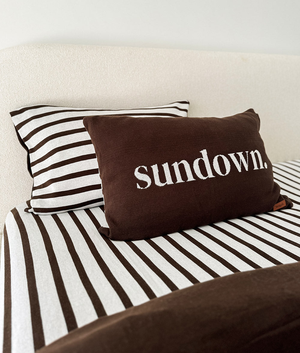 Sundown Stripe jersey cotton fitted sheet with the "Sundown" cushion.
