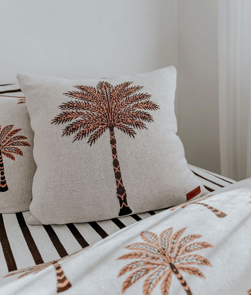 Peach Sundown Palm Motif cushion cover styled with matching bedding.