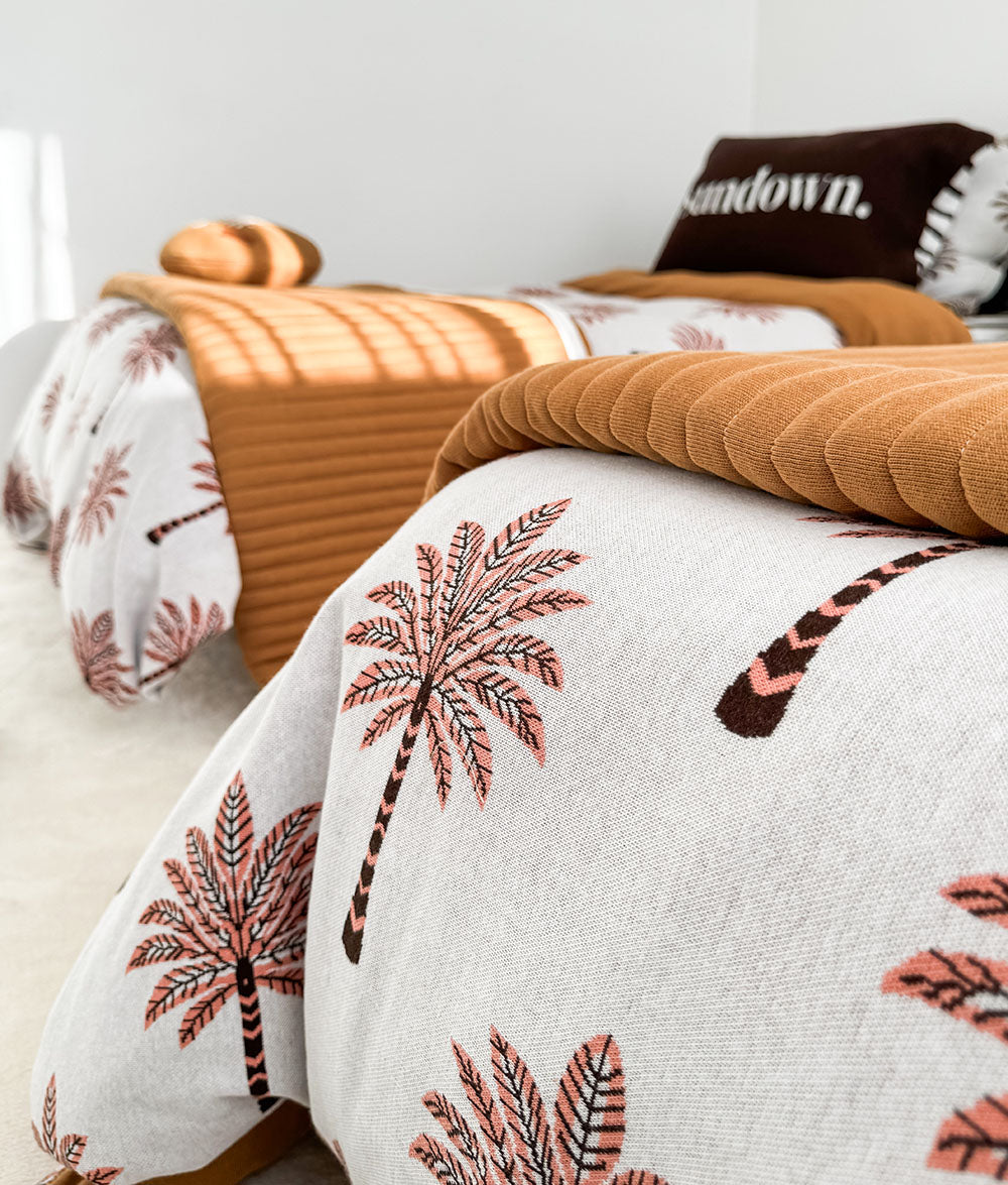 Peach Sundown jersey cotton duvet cover with matching tobacco quilt.
