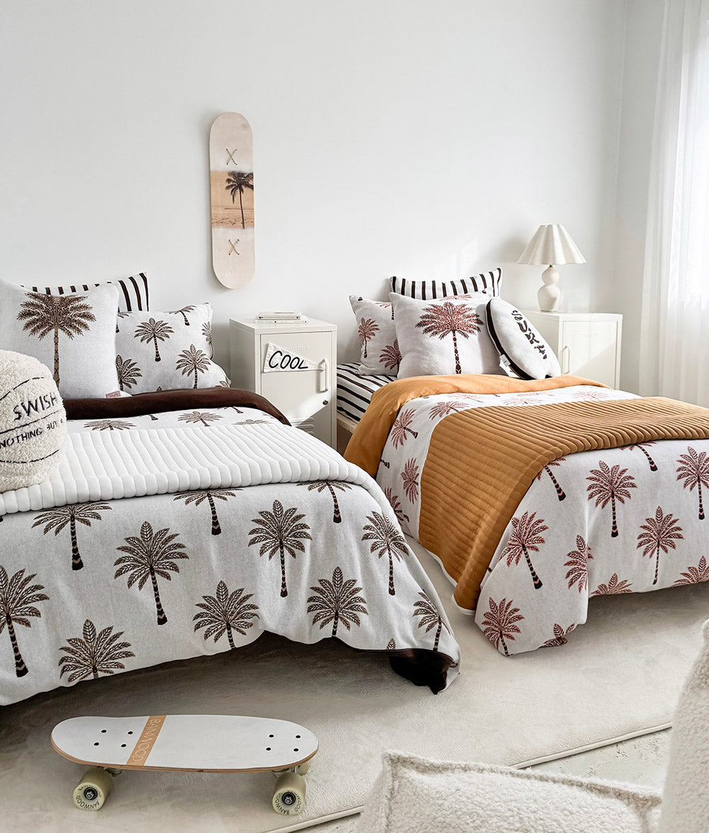 Khaki Sundown reversible quilt styled on matching single beds.
