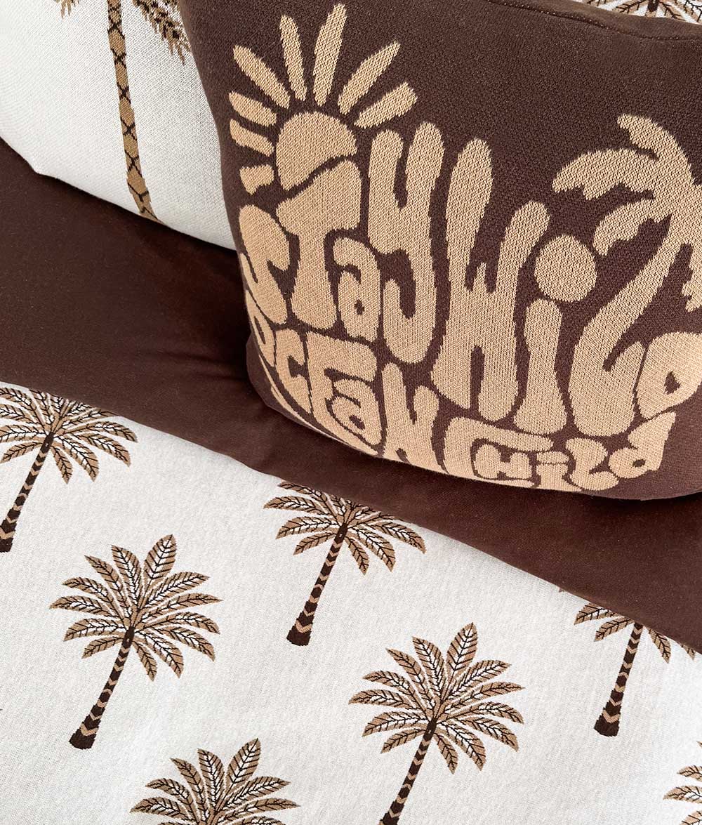Khaki Sundown jersey cotton duvet cover styled with the Stay Wild Ocean Child cushion.