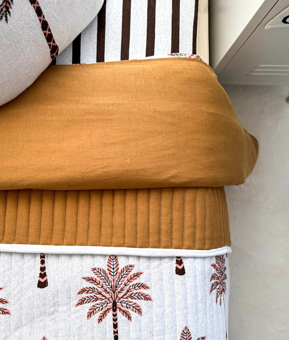 Peach Sundown jersey cotton duvet cover with plain tobacco reverse.