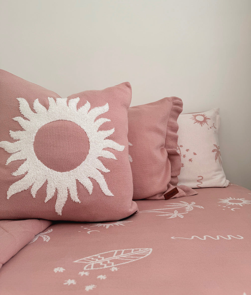 Pink Sol cushion cover styled with matching palm tree pillowcase.