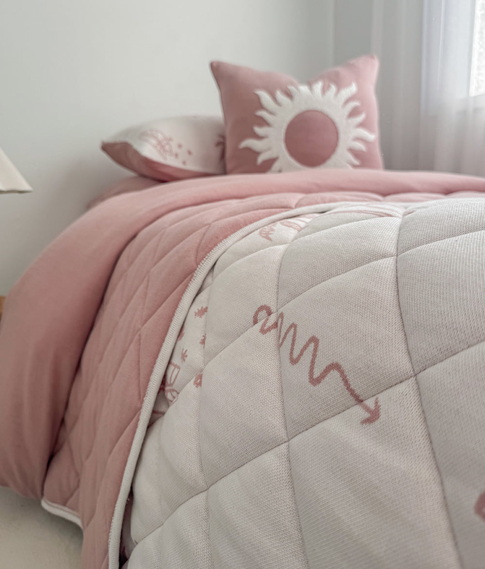 Sun Kissed reversible quilt styled with matching jersey cotton bedding.