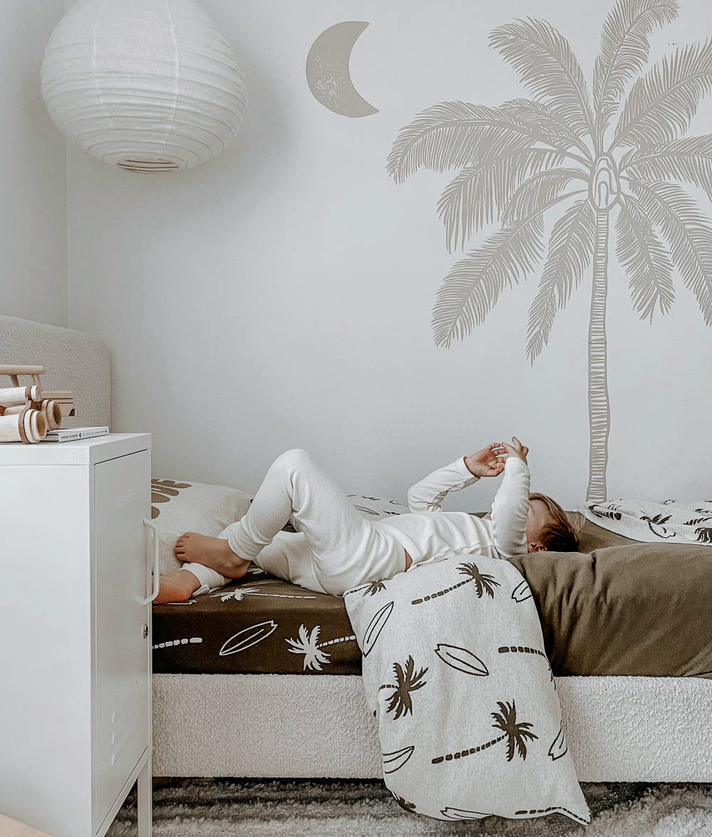 Olive Surfing Palm bedding styled with matching pillowcase.