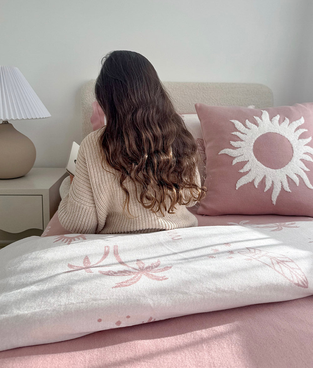 Pink Sol cushion cover styled with Sun Kissed bedding.