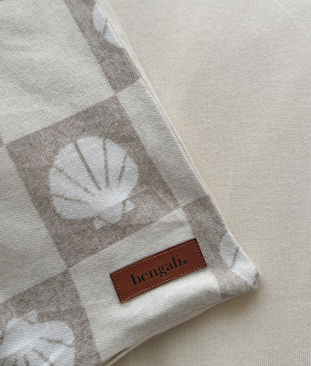 Fabric with shell pattern and 'bengali' label on a neutral background