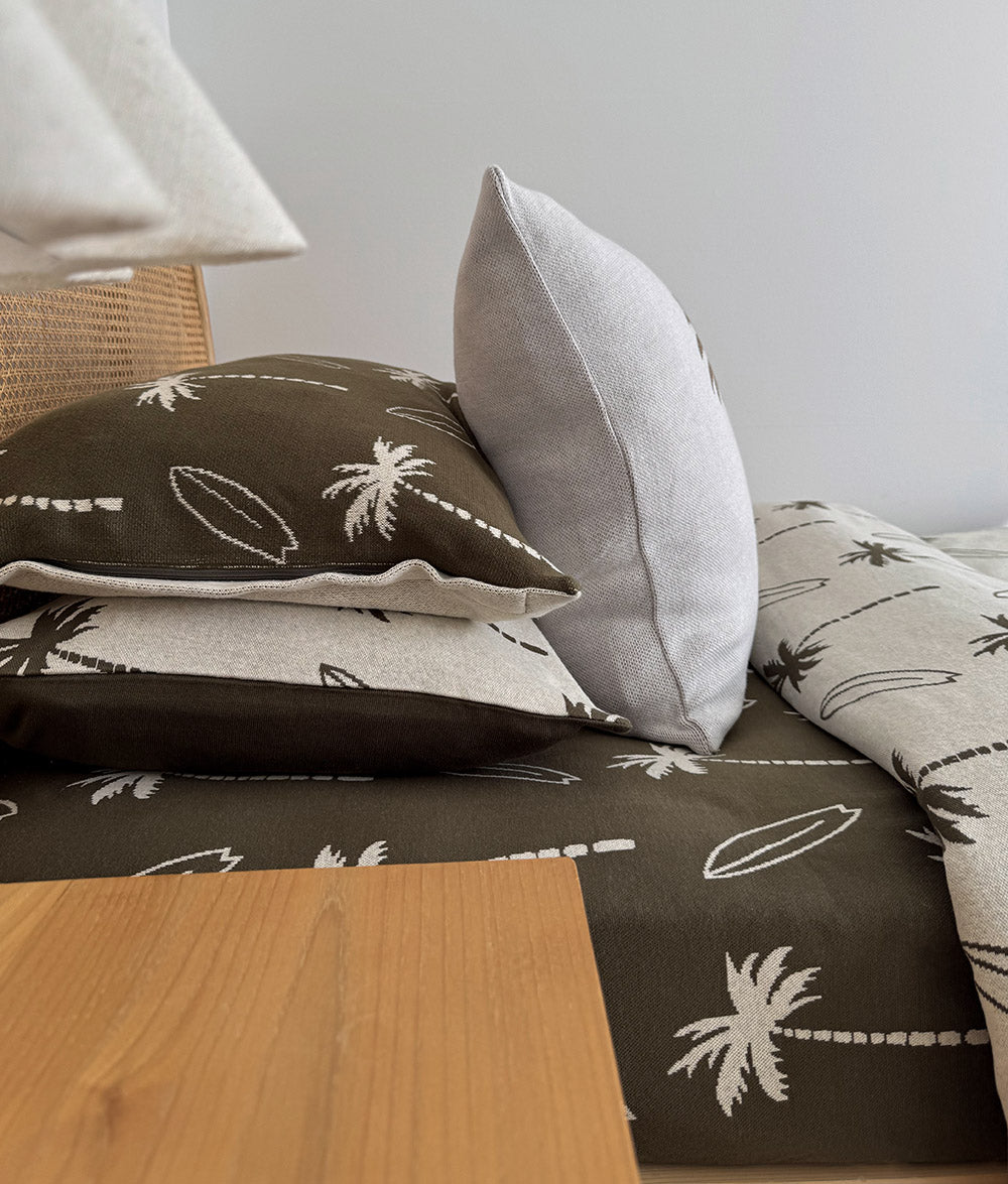 Olive Surfing Palm duvet cover styled with matching pillowcases.