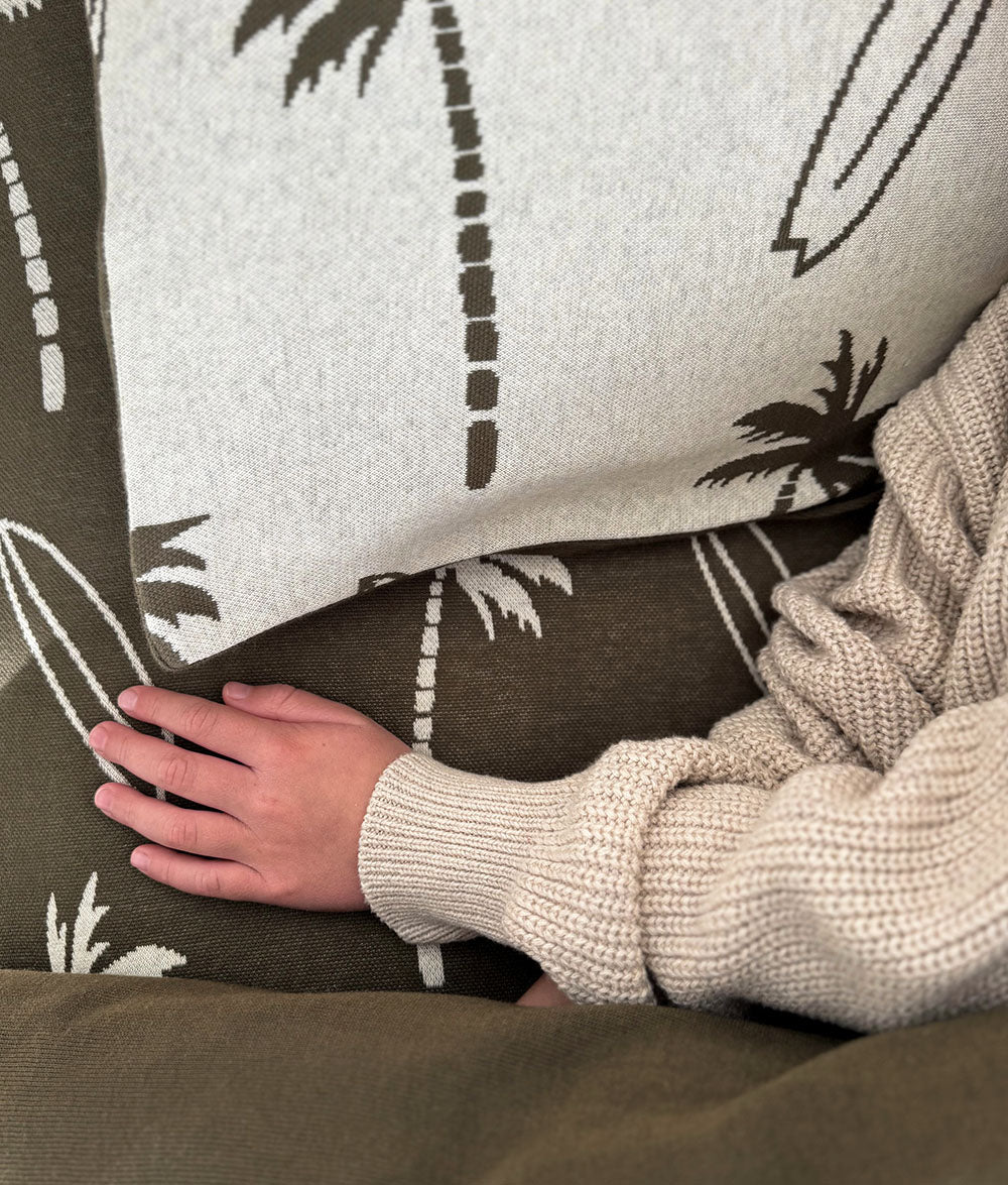Close-up of Olive Surfing Palm fitted sheet and matching pillowcase.