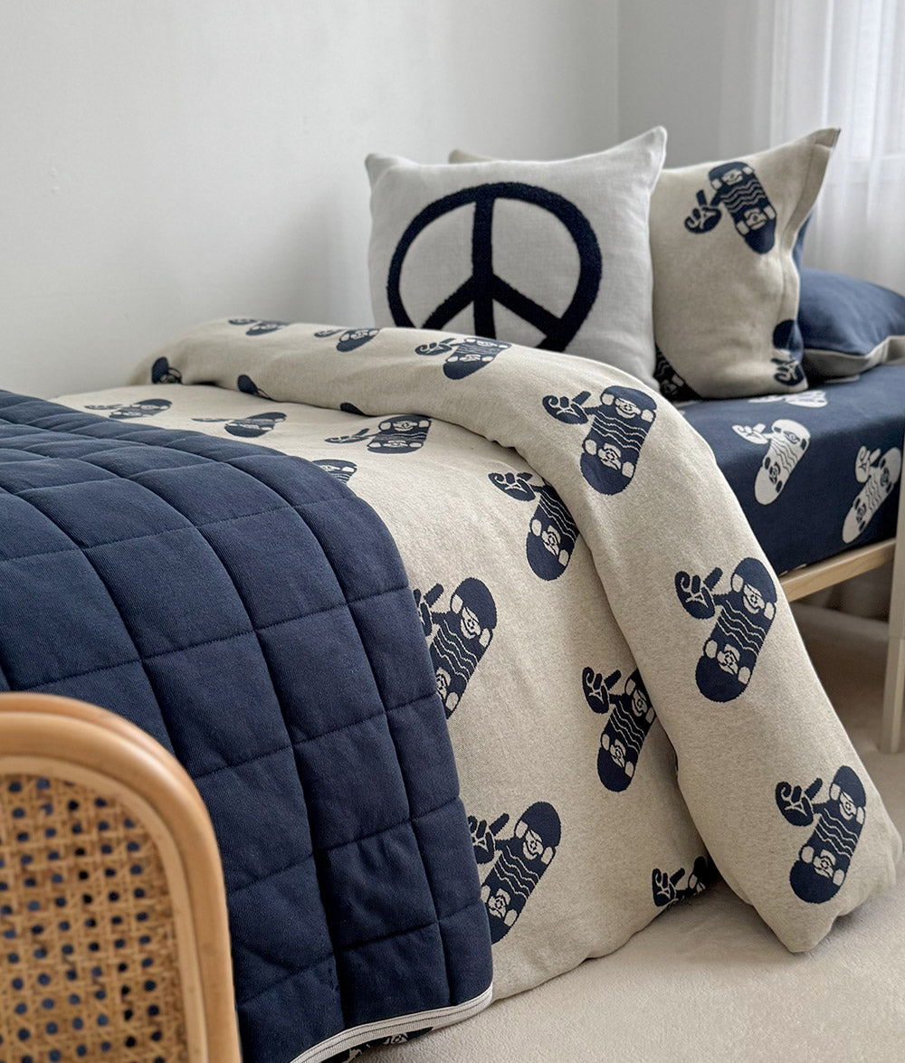 Tidal Blue Skater Life jersey cotton duvet cover styled with matching quilt and Peace cushion.