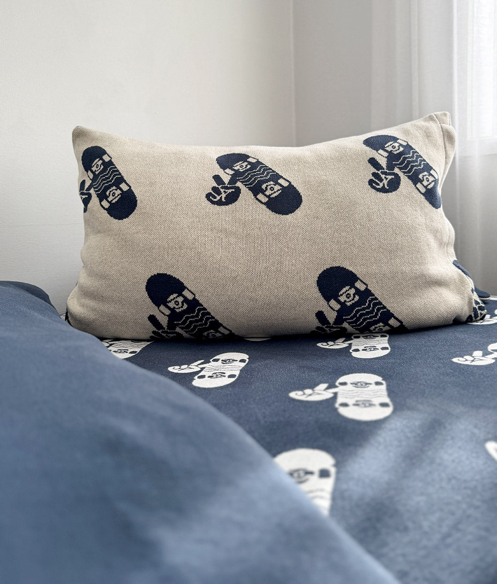 "Skaters Gonna Skate" cushion cover styled on a child's bed.