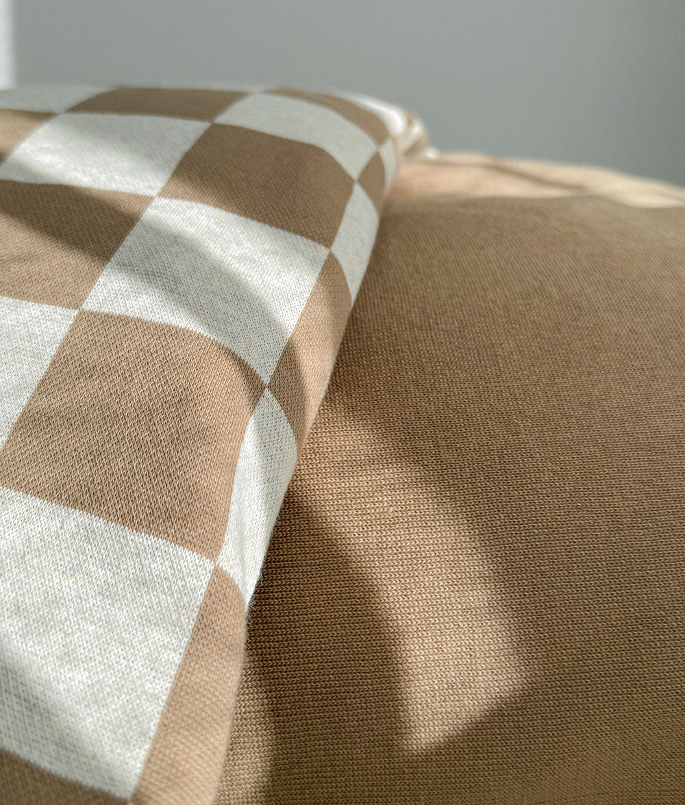 Folded Khaki Gingham duvet cover with a plain khaki brown reverse.