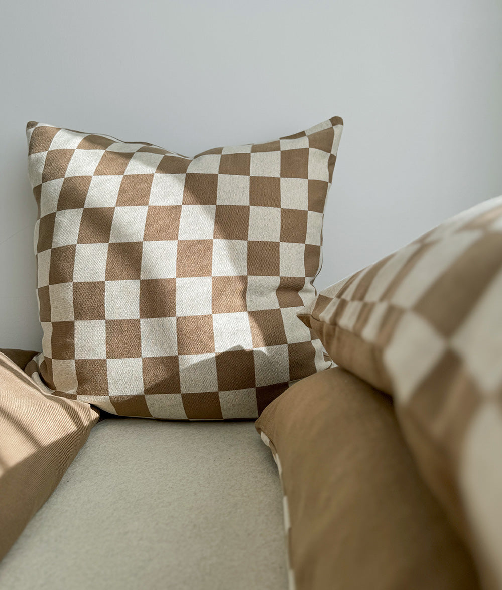 Khaki Gingham Euro pillowcase styled on a made bed.