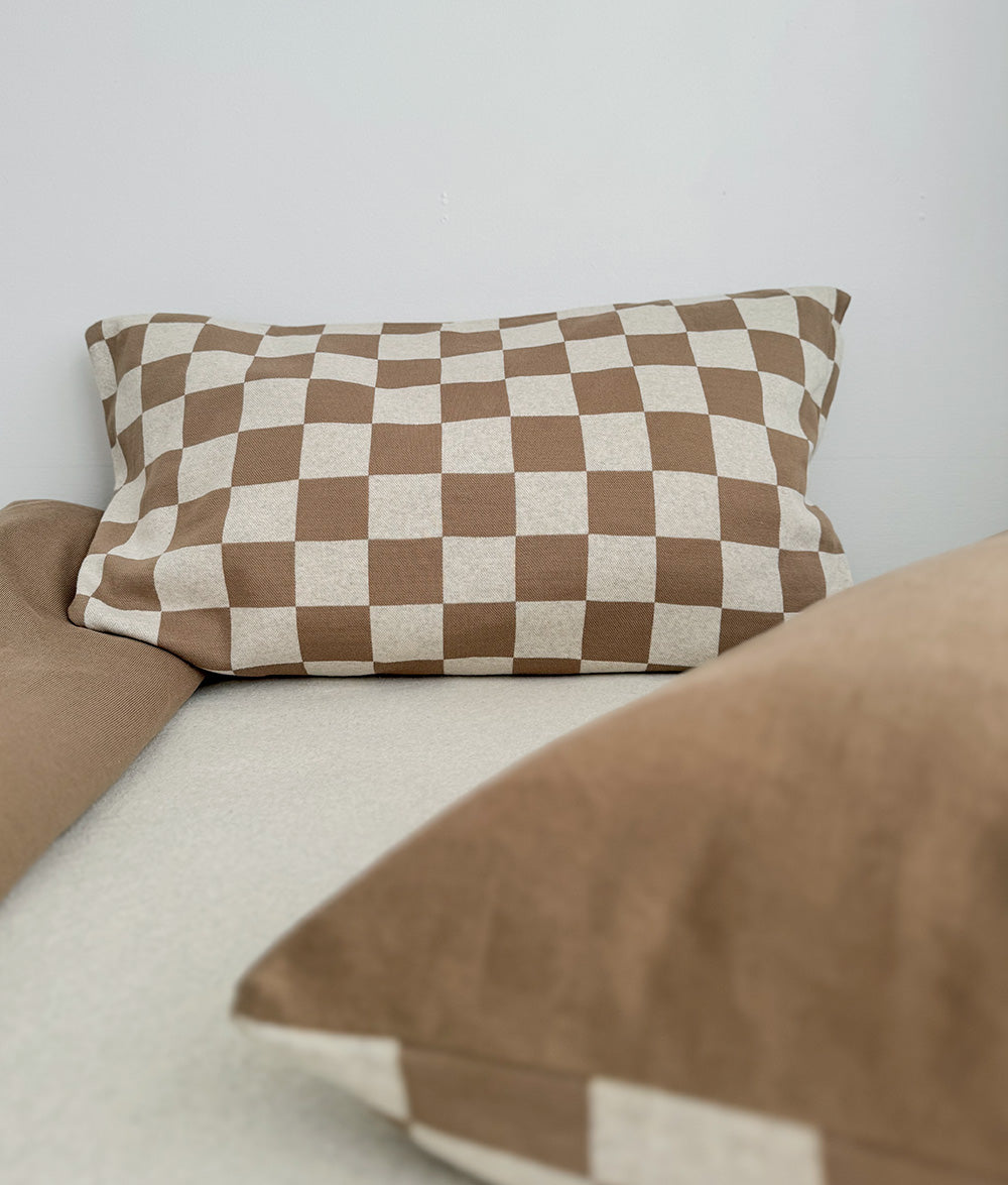 Khaki Gingham reversible pillowcase styled on a child's bed.