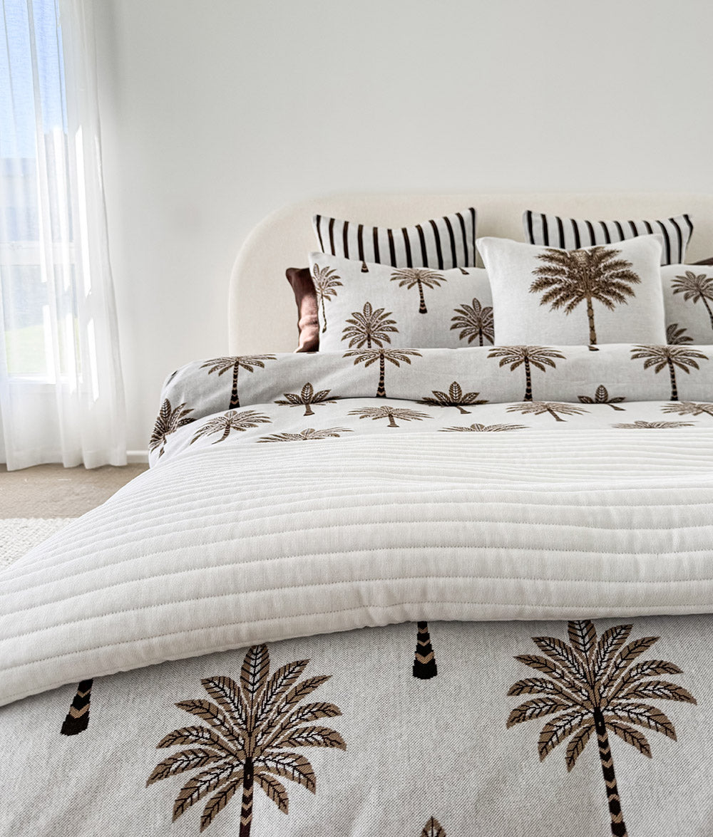 Khaki Sundown reversible pillowcase styled on a made bed.