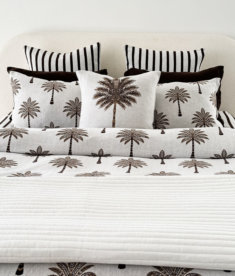 Khaki Palm Motif cushion cover styled with matching Khaki Sundown bedding.