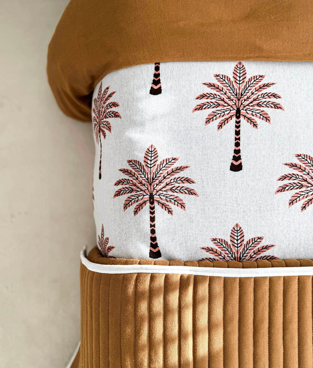 Peach Sundown jersey cotton duvet cover folded to show the plain tobacco reverse.