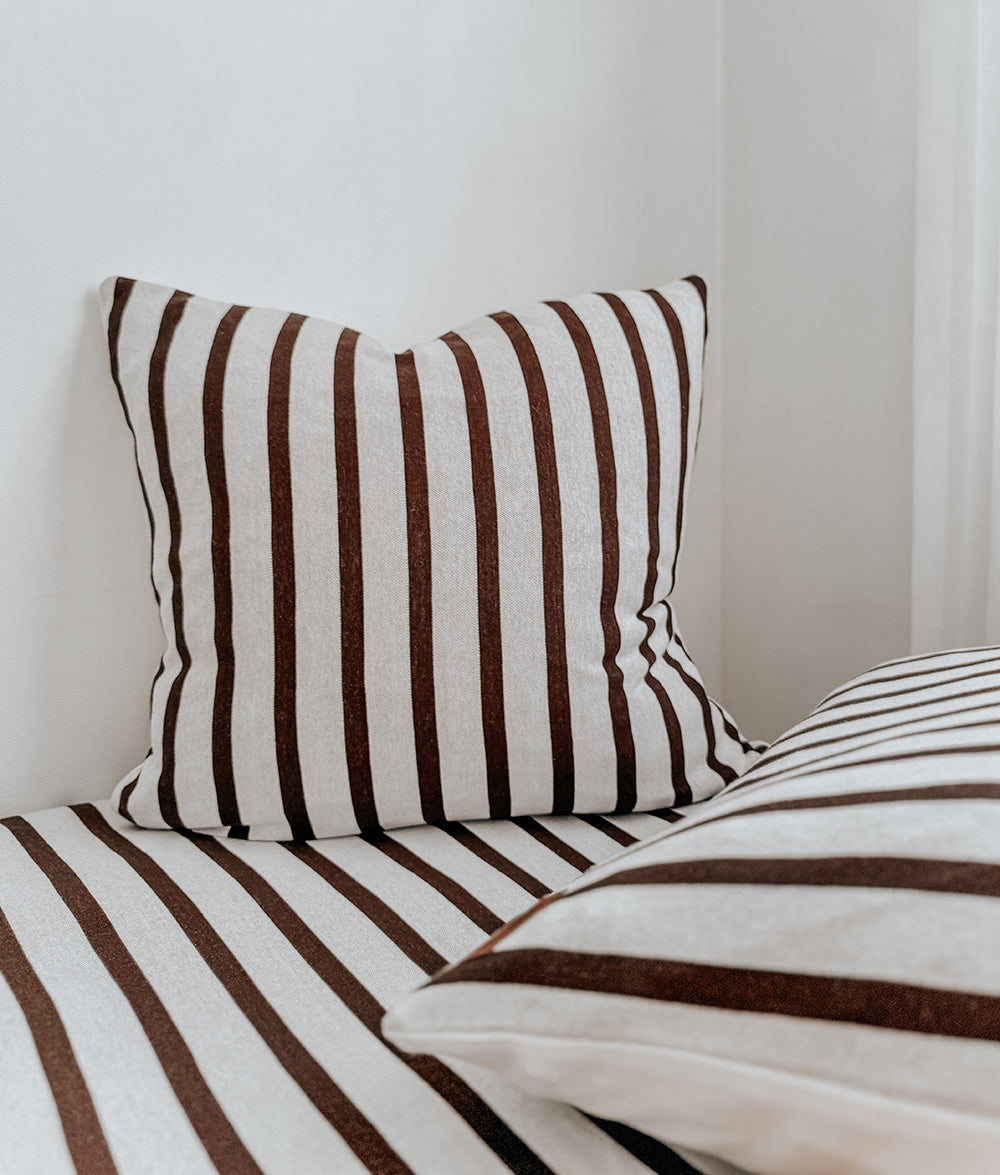 Sundown Stripe Euro pillowcase styled with matching Sundown Stripe bedding.