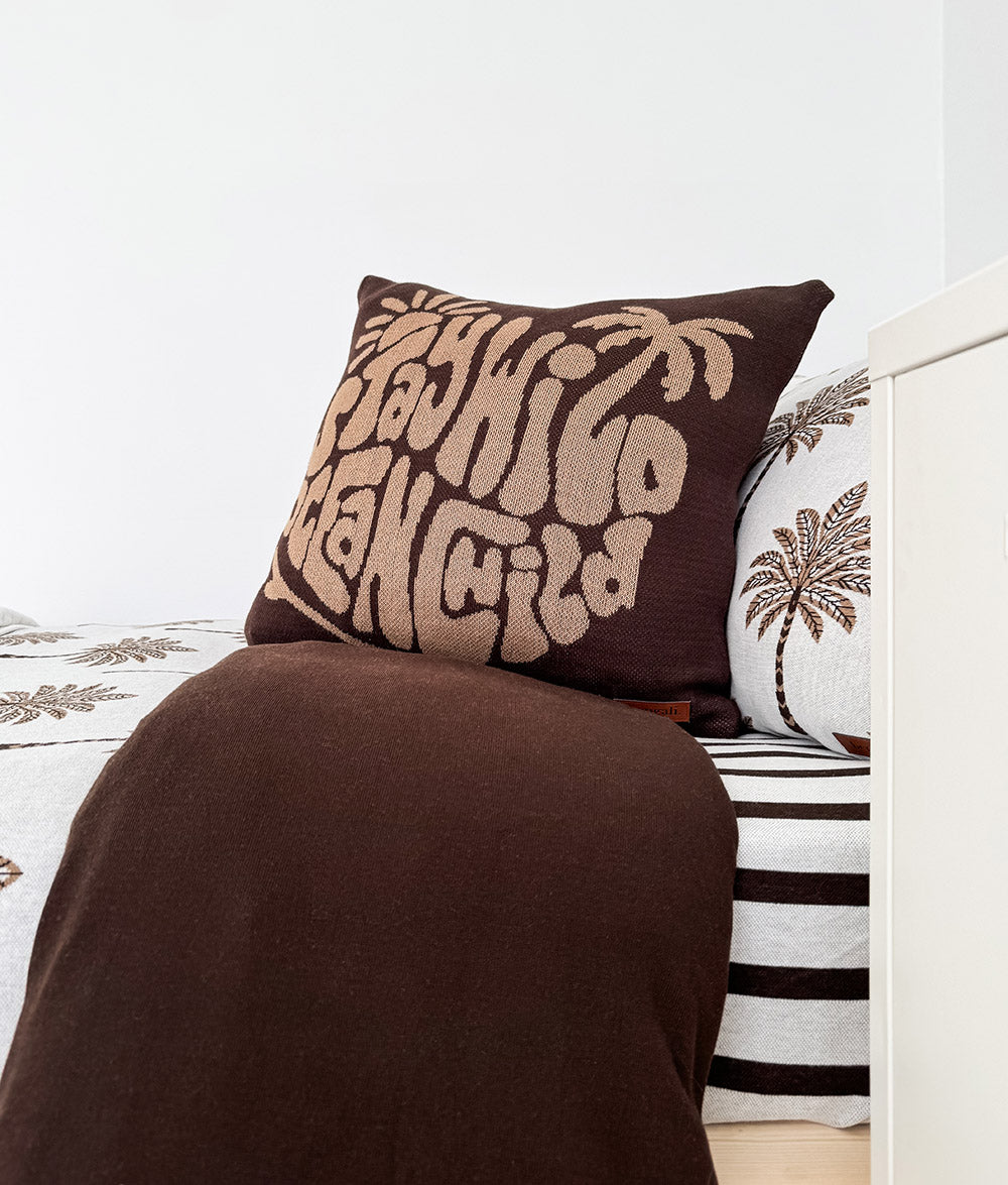 "Stay Wild Ocean Child" cushion cover in chocolate.