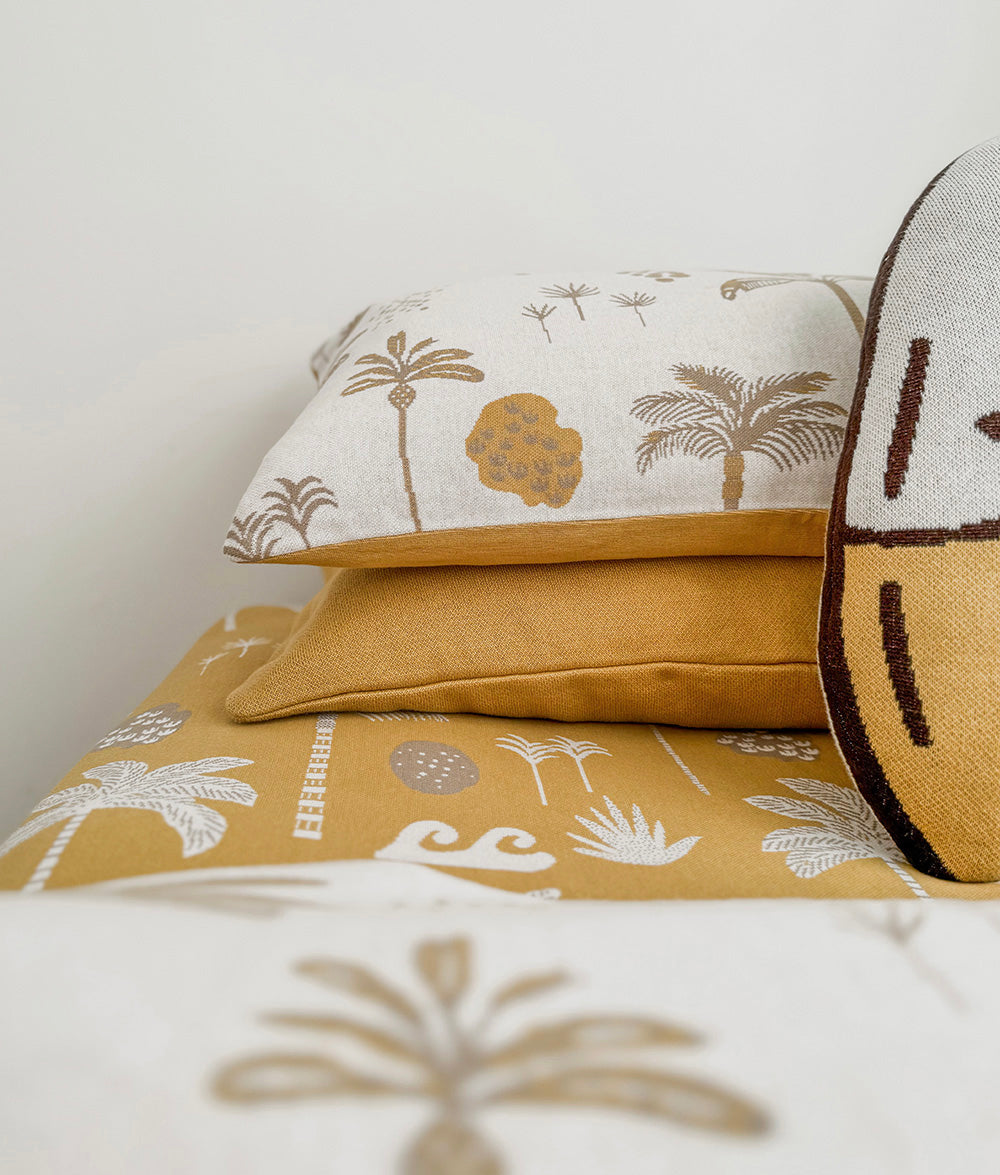 Golden Hour reversible pillowcase styled with matching Golden Hour bedding.