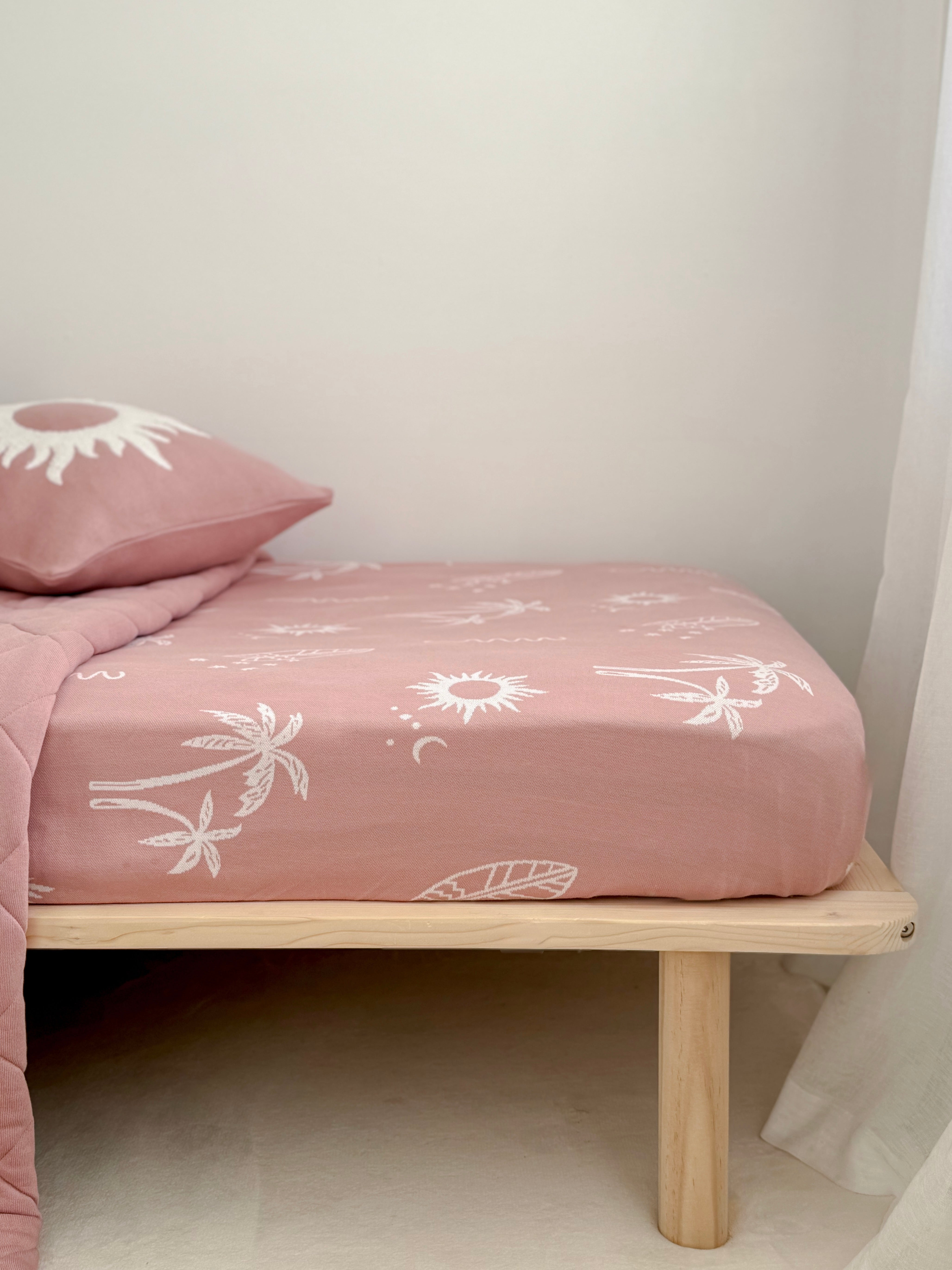 Sun Kissed jersey cotton fitted sheet styled on a child's bed.