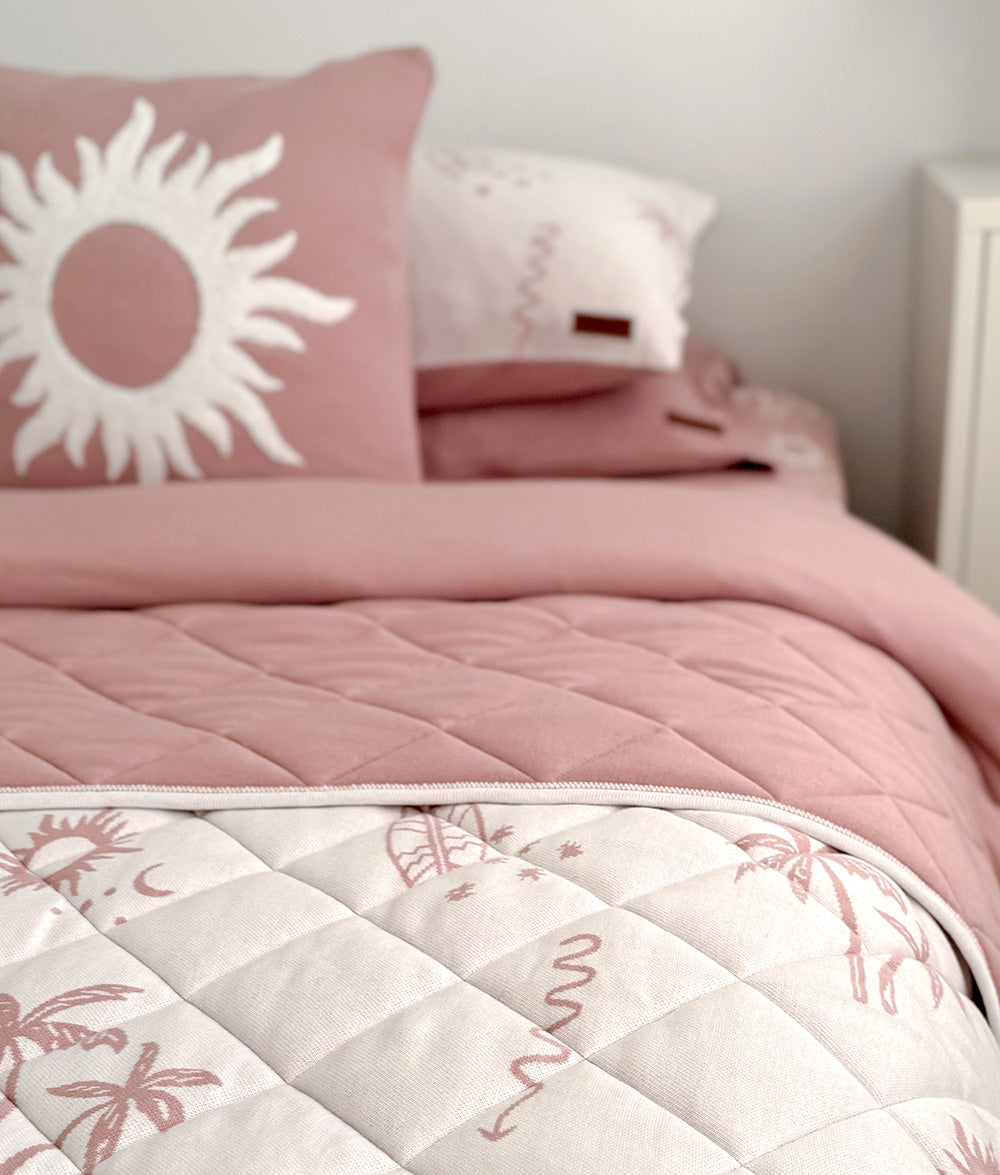 Sun Kissed reversible quilt styled with matching Sun cushion.