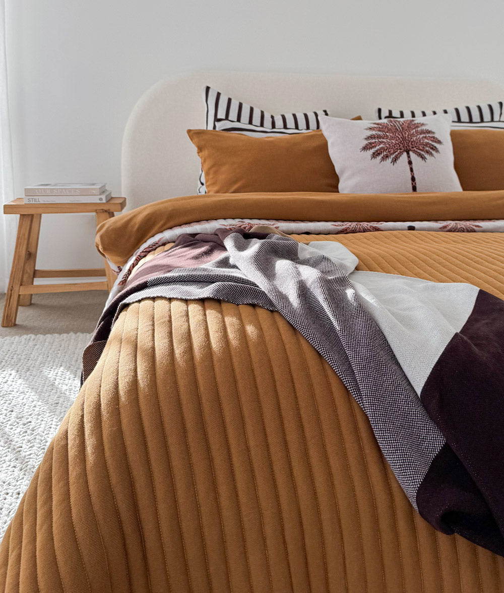 Sundown Stripe Euro pillowcase styled with coordinating Tobacco and Sundown collection bedding.