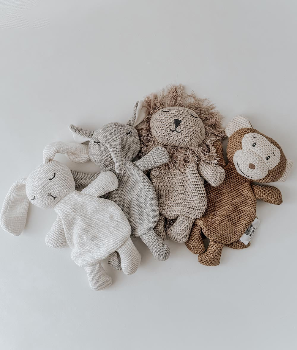 Three soft toy animals on a white background