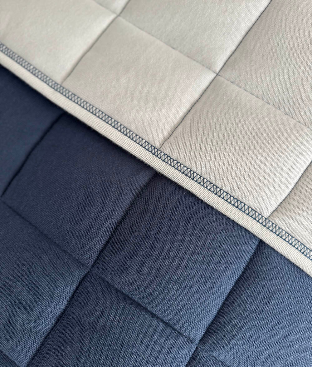 Close-up of the Tidal Blue quilt with quilted stitching.