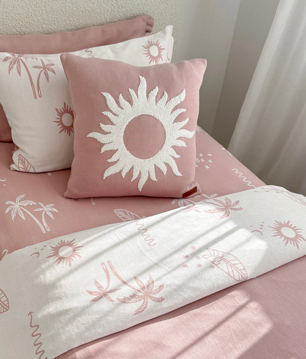 Sun Kissed reversible pillowcase styled with matching Sun cushion.