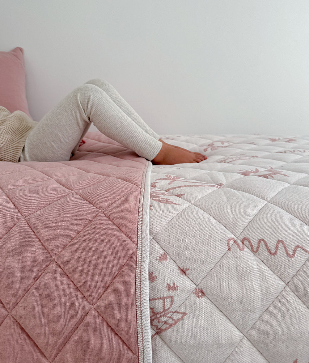 Sun Kissed reversible quilt styled on a child's bed.