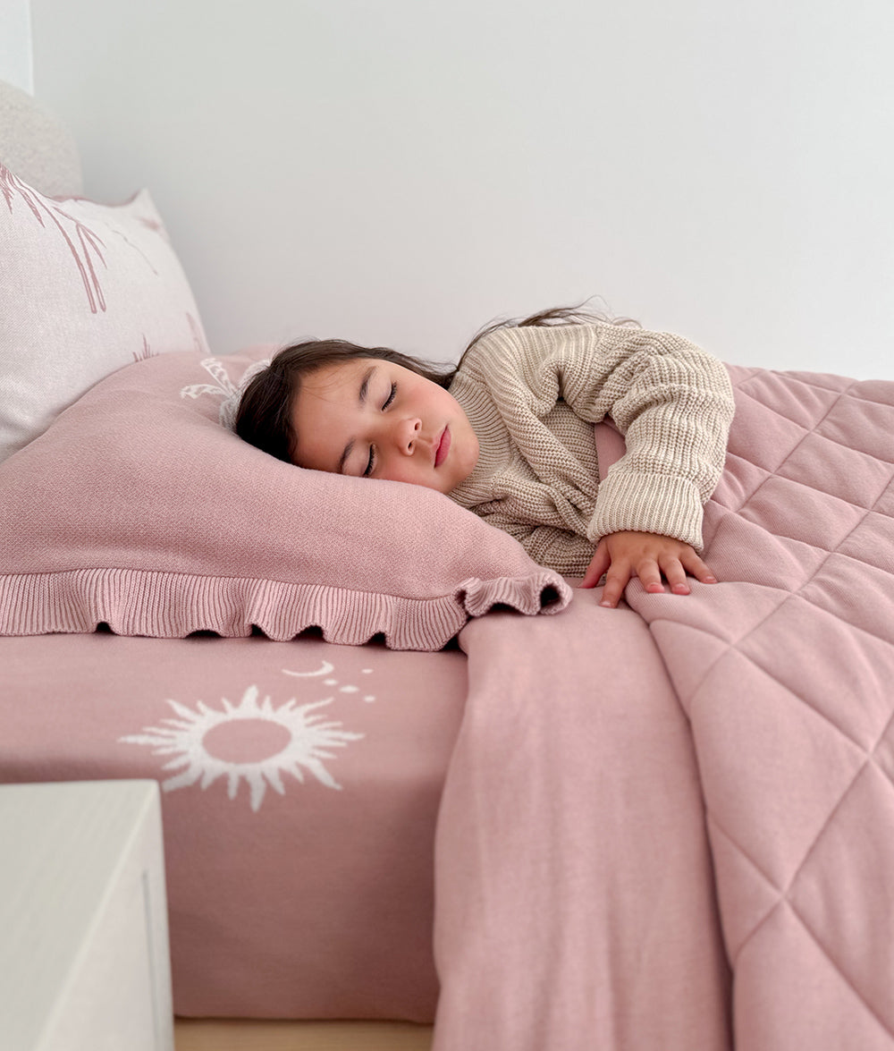 Child resting on the Sun Kissed jersey cotton fitted sheet.