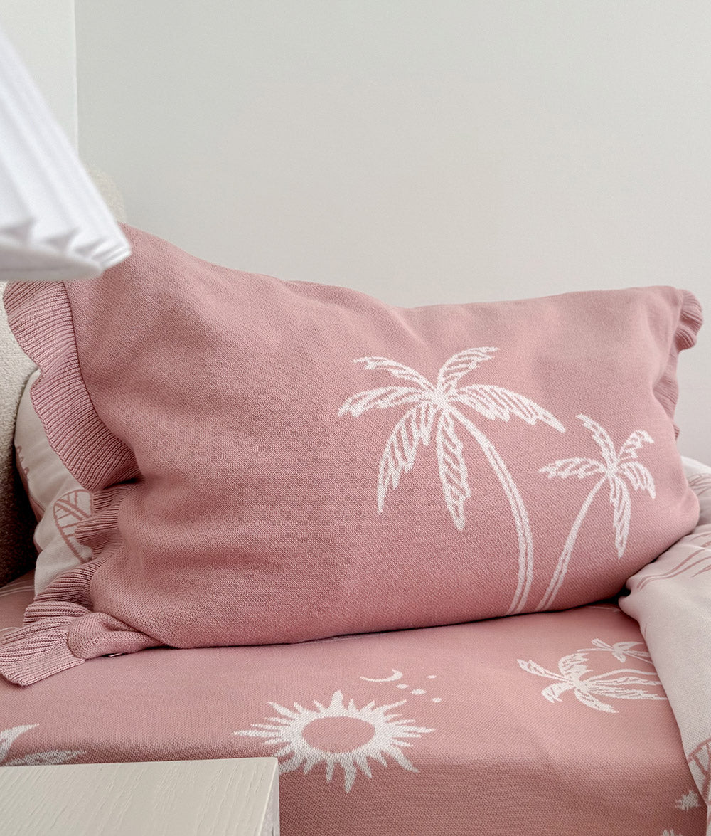Sun Kissed jersey cotton fitted sheet styled with matching palm pillowcase.