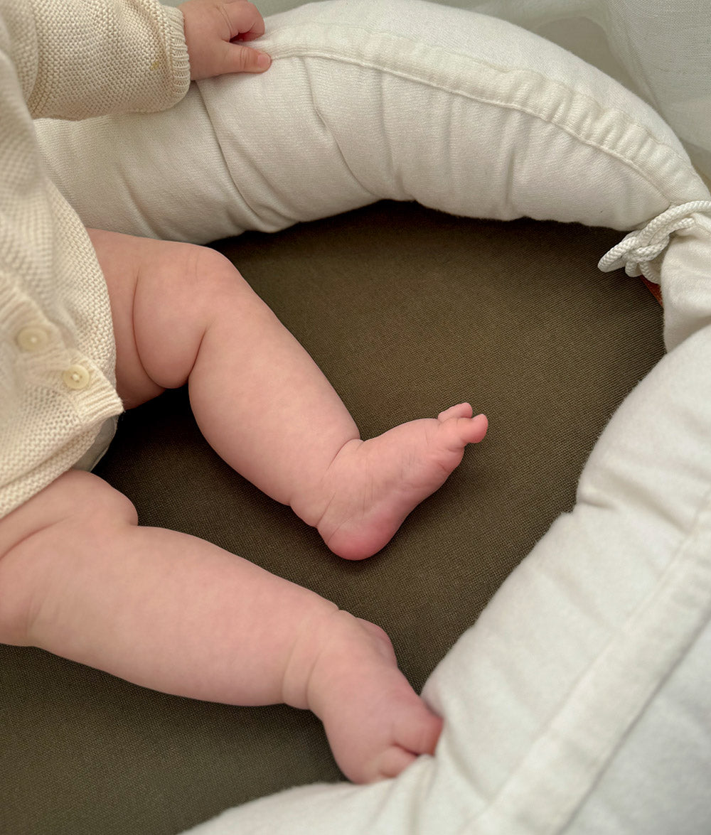 Ivory & Olive Baby Lounger with soft quilted sides.