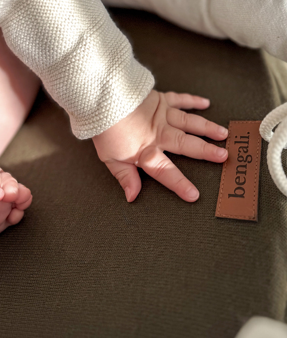 Close-up of the Ivory & Olive Baby Lounger with Bengali leather label.