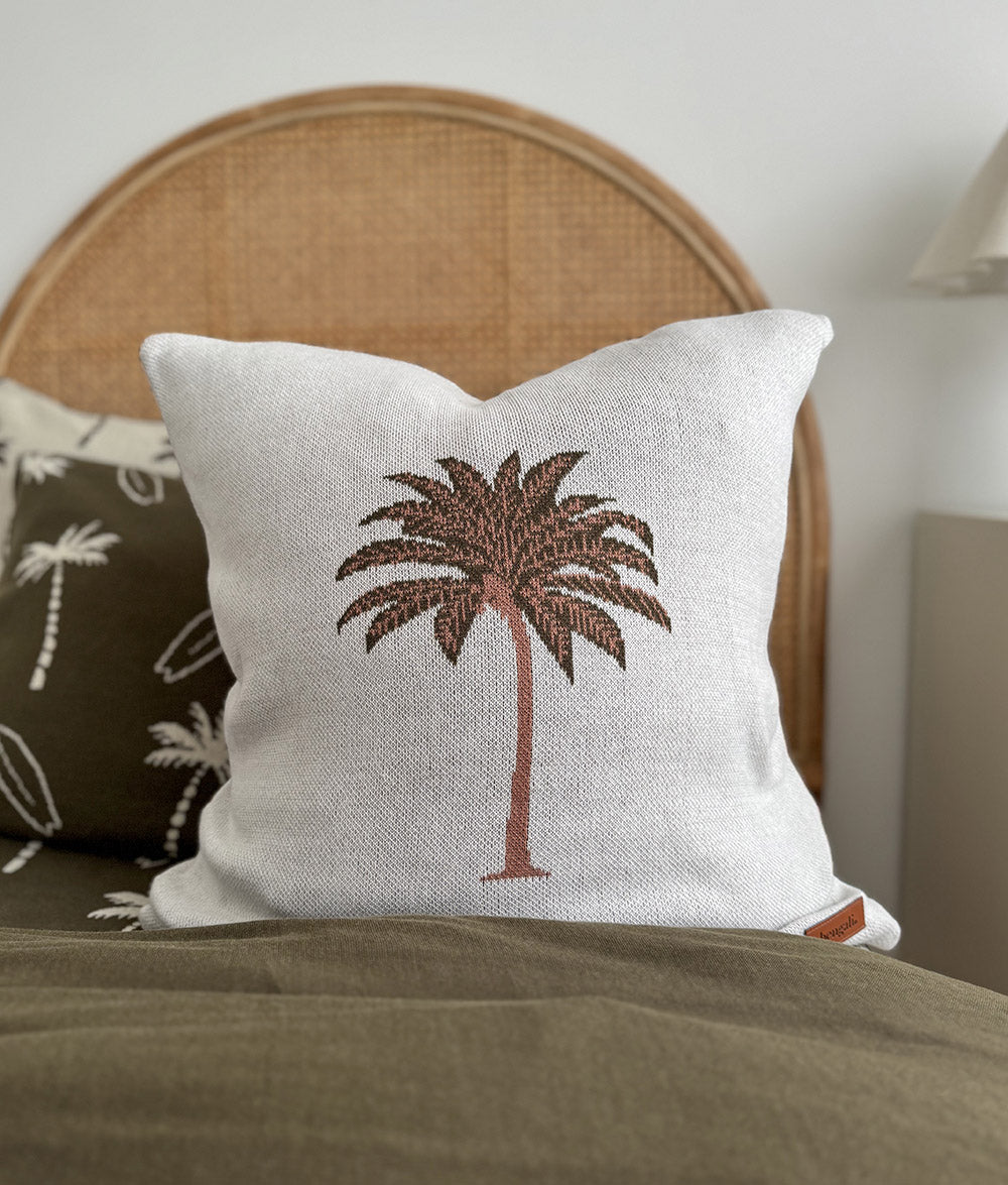 Olive Palm Motif cushion cover styled with matching Olive Surfing Palm bedding.