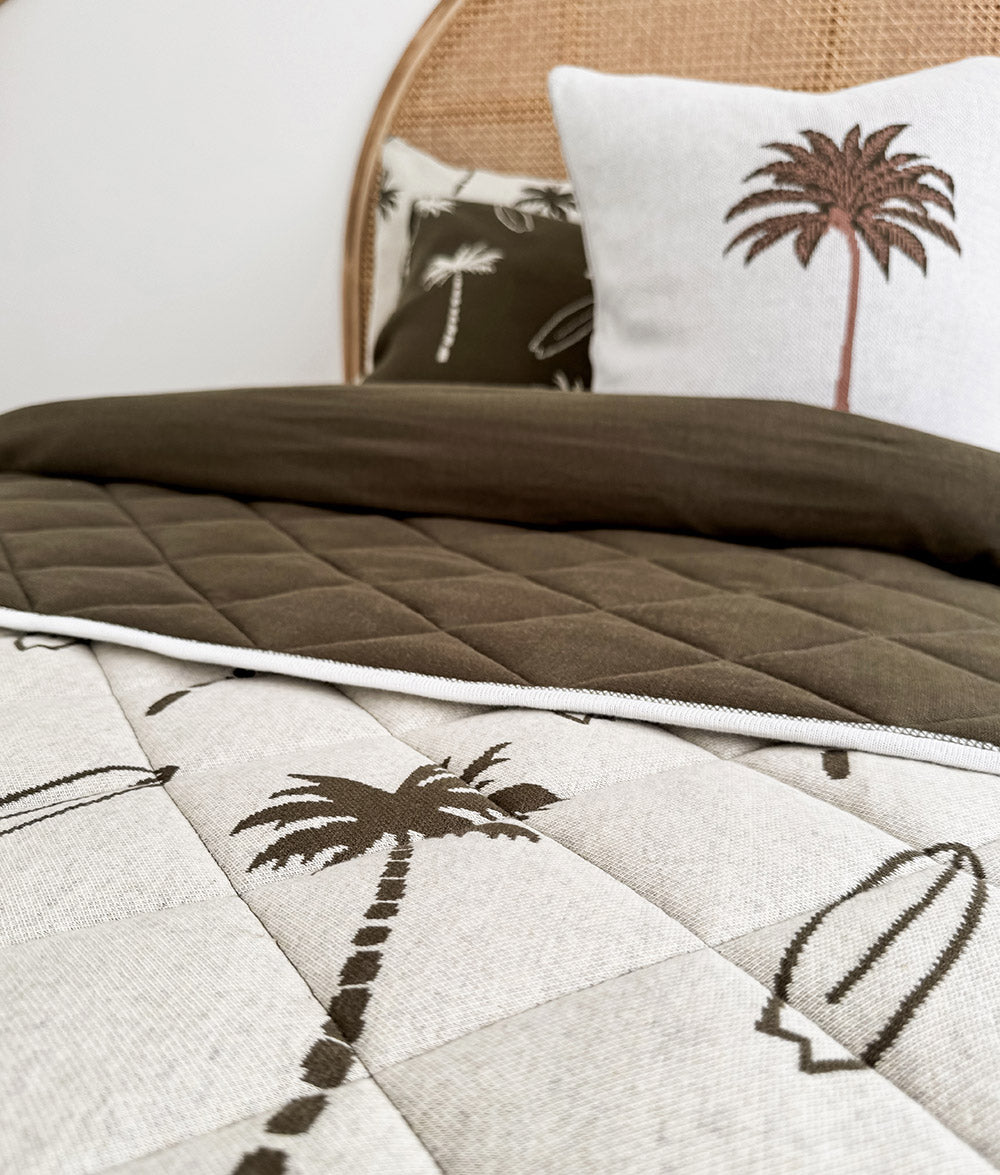 Close-up of Olive Surfing Palm duvet cover with palm tree print.