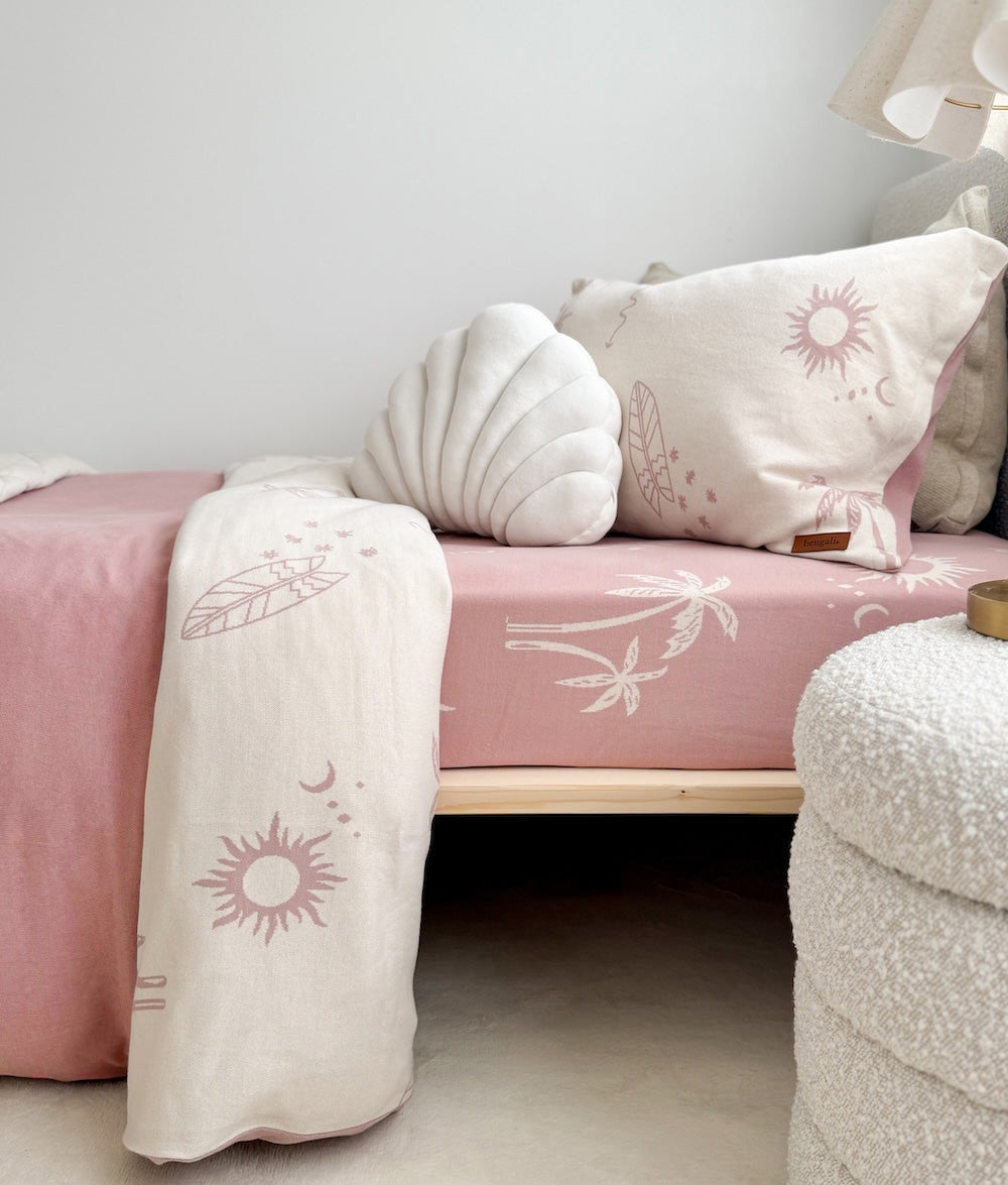 Sun Kissed reversible pillowcase styled with matching duvet cover and ivory shell cushion.