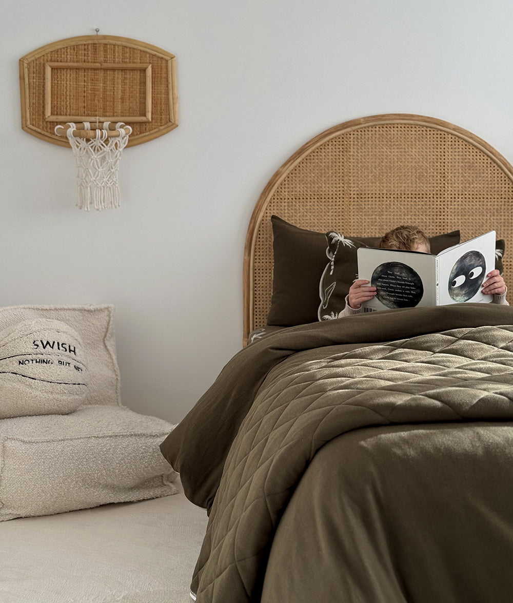 Olive Surfing Palm bedding styled in a child's bedroom.