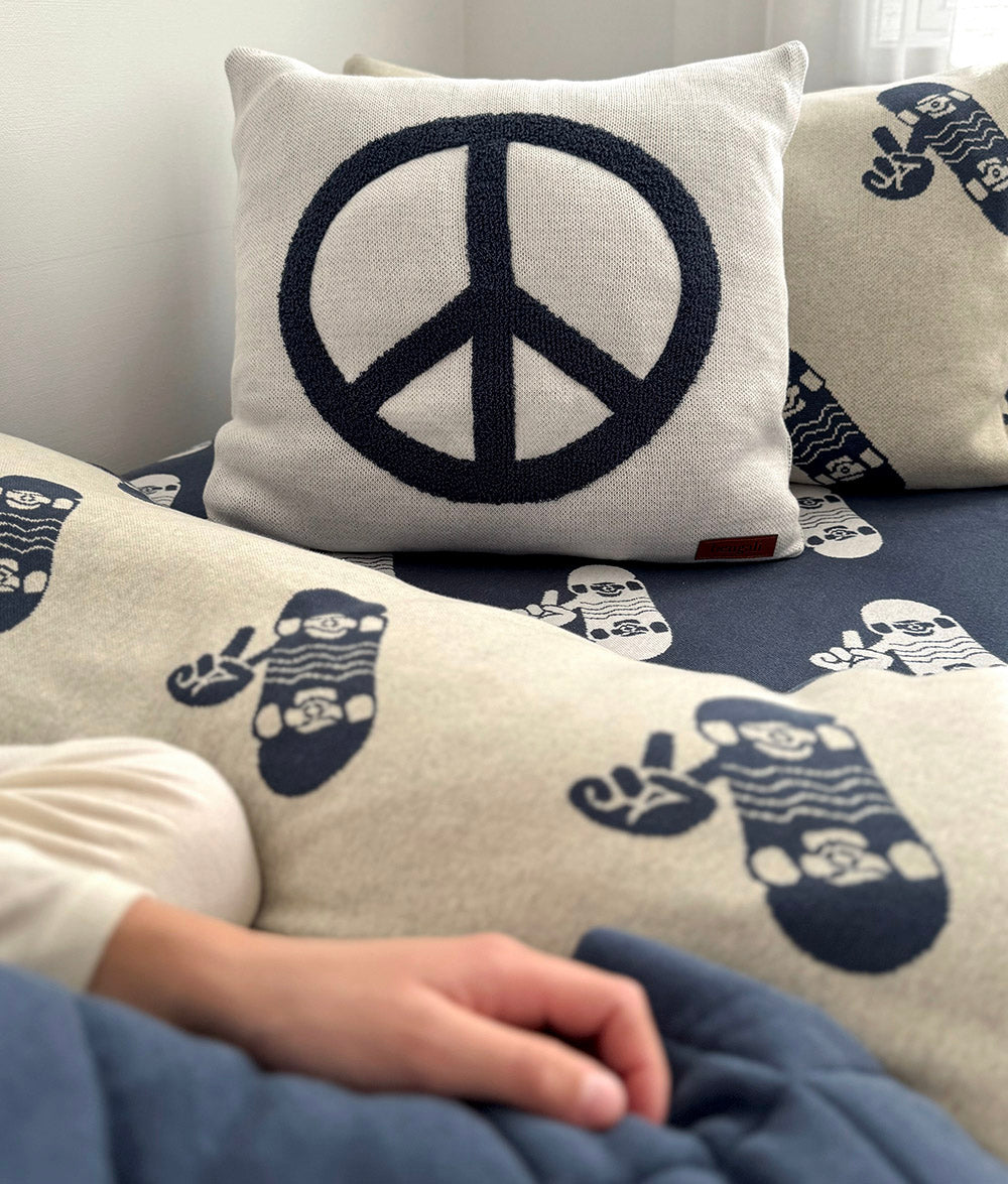 Peace cushion styled with Tidal Blue Skater Life jersey cotton bedding.