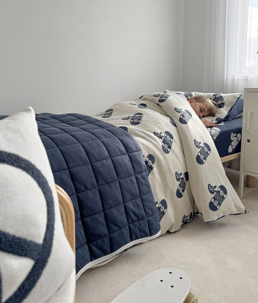 Tidal Blue Skater Life jersey cotton duvet cover styled on a child's bed.