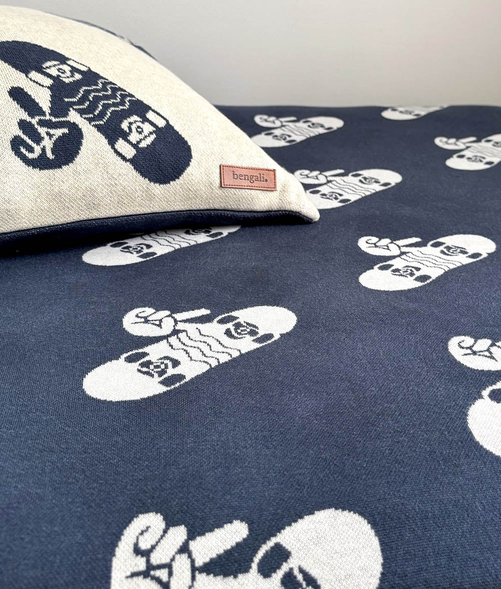 Close-up of the "Skaters Gonna Skate" cushion cover on Tidal Blue Skater Life bedding.