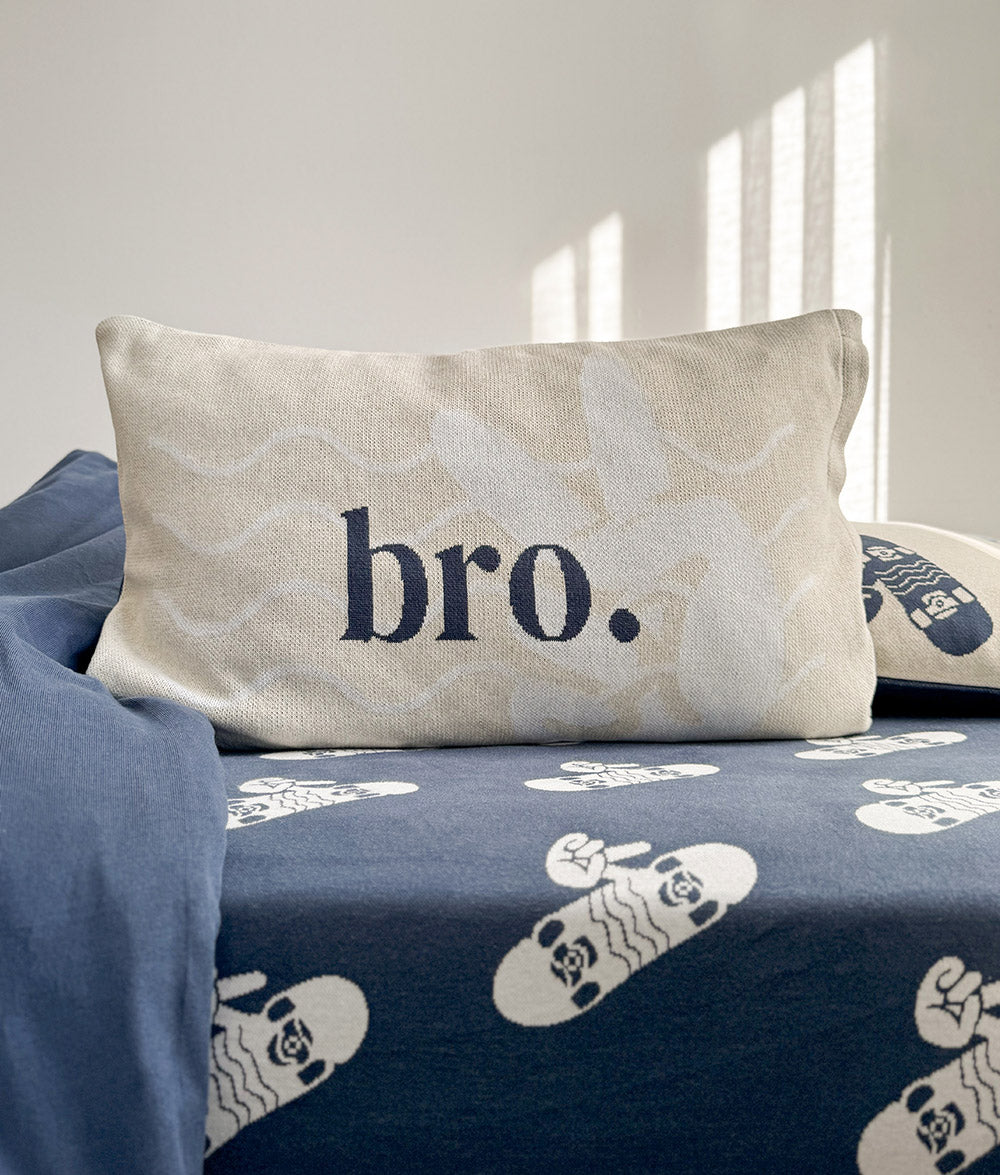 Close-up of the "bro." reversible pillowcase on the tidal blue jersey cotton sheet.