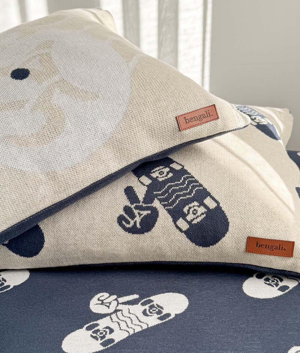 Stacked Skater Life pillowcases in soft jersey cotton, featuring navy and natural colourways with ivory skateboard and peace hand prints, styled on the matching navy fitted sheet.